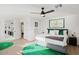 Main bedroom features a ceiling fan, a king bed, and an ensuite bathroom at 29228 N 48Th St, Cave Creek, AZ 85331