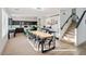 Open concept dining room with large table, modern chandelier, stairs, and dark cabinets at 29228 N 48Th St, Cave Creek, AZ 85331