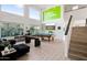 Bright open game room featuring high ceilings, a pool table, shuffleboard table, and a comfortable seating area at 29228 N 48Th St, Cave Creek, AZ 85331