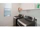 Laundry room featuring modern gray washer and dryer, window, and storage shelf at 29228 N 48Th St, Cave Creek, AZ 85331