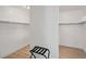 Walk-in closet with wood flooring and built-in shelving at 29228 N 48Th St, Cave Creek, AZ 85331