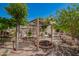 Landscaped backyard featuring pergola, mature trees, and garden beds on a brick patio at 29399 N 67Th Ave, Peoria, AZ 85383