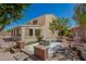 A beautifully landscaped backyard with a patio area, stone accents, and mature trees at 29399 N 67Th Ave, Peoria, AZ 85383