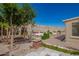 Nicely landscaped backyard with synthetic turf seating, mature trees, and a brick-lined walkway at 29399 N 67Th Ave, Peoria, AZ 85383