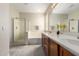 Bright bathroom with a glass enclosed shower, tub, double sinks, and plenty of counter space at 29399 N 67Th Ave, Peoria, AZ 85383