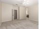View of a spacious bedroom leading to a bathroom with dual vanity at 29399 N 67Th Ave, Peoria, AZ 85383