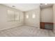 Bright bedroom with neutral carpeting, a window, and a built-in desk, creating a versatile space at 29399 N 67Th Ave, Peoria, AZ 85383