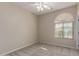 Bedroom with modern fan, large window, carpeted flooring, and neutral colored walls at 29399 N 67Th Ave, Peoria, AZ 85383