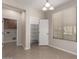 Dining area features tile flooring, a window with blinds, and access to the pantry and laundry room at 29399 N 67Th Ave, Peoria, AZ 85383