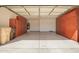 Spacious garage with ample cabinet storage, epoxy flooring, and access door to the house at 29399 N 67Th Ave, Peoria, AZ 85383