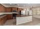 Bright kitchen features an island, granite countertops, stainless steel appliances, tile floor, and wood cabinets at 29399 N 67Th Ave, Peoria, AZ 85383