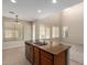 Bright kitchen featuring an island with granite countertops, a stainless steel sink, and tile floors at 29399 N 67Th Ave, Peoria, AZ 85383