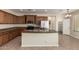 Well-equipped kitchen features an island, tile flooring, stainless steel appliances, and wood cabinets at 29399 N 67Th Ave, Peoria, AZ 85383
