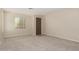 Bright and airy living room with carpeting, neutral paint, and entrance at 29399 N 67Th Ave, Peoria, AZ 85383