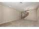 Bright and airy living room with carpeting, modern lighting, and staircase at 29399 N 67Th Ave, Peoria, AZ 85383