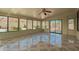 Sunroom featuring tile flooring, ceiling fan, and large windows with view of desert backyard at 29399 N 67Th Ave, Peoria, AZ 85383
