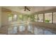 Bright sunroom with tile flooring, ceiling fan, and large windows offering backyard views at 29399 N 67Th Ave, Peoria, AZ 85383