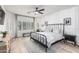 Well-lit bedroom with hardwood floors, neutral colors, shutters, and modern decor at 3067 E Trigger Way, Gilbert, AZ 85297