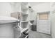 This walk-in closet is organized with white shelves and drawers for optimal storage at 3067 E Trigger Way, Gilbert, AZ 85297