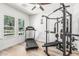 Bright exercise room with hardwood floors, weight training equipment, and a treadmill by the window at 3067 E Trigger Way, Gilbert, AZ 85297