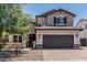 Charming two-story home with a spacious driveway, desert landscaping, and a convenient two-car garage at 3067 E Trigger Way, Gilbert, AZ 85297