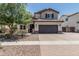 Charming two-story home featuring a spacious driveway, desert landscaping, and a two-car garage at 3067 E Trigger Way, Gilbert, AZ 85297