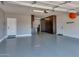 Clean garage with painted floor and built-in cabinets at 3067 E Trigger Way, Gilbert, AZ 85297