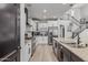 Gourmet kitchen features stainless steel appliances, granite countertops, and wood floors at 3067 E Trigger Way, Gilbert, AZ 85297