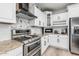 Updated kitchen featuring white cabinets, granite countertops, and stainless steel appliances at 3067 E Trigger Way, Gilbert, AZ 85297