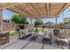 Charming outdoor living area with a covered pergola, comfortable seating, and stylish decor, perfect for entertaining guests at 3067 E Trigger Way, Gilbert, AZ 85297
