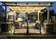 Inviting outdoor living space with a pergola, comfortable seating, and ambient lighting, perfect for evening relaxation by the pool at 3067 E Trigger Way, Gilbert, AZ 85297