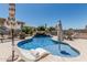 Gorgeous pool featuring a rock waterfall, complemented by stylish lounge chairs and shade umbrellas on a sunny day at 3067 E Trigger Way, Gilbert, AZ 85297