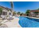 Inviting backyard oasis with a sparkling pool, cozy fire pit, and a shaded pergola, perfect for outdoor relaxation at 3067 E Trigger Way, Gilbert, AZ 85297
