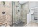 This modern shower has stylish neutral tile, a built in bench, and a glass enclosure at 3067 E Trigger Way, Gilbert, AZ 85297