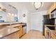 Well-lit kitchen featuring stainless steel appliances, light wood cabinetry, and tiled flooring at 3236 E Chandler Blvd # 1076, Phoenix, AZ 85048