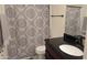 Bathroom showcases patterned shower curtain, black fixtures, vanity with dark countertop and gray accent towels at 3345 E University Dr # 47, Mesa, AZ 85213