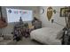 This bedroom is decorated with a eclectic style and features a cozy bed, plants and natural light at 3345 E University Dr # 47, Mesa, AZ 85213