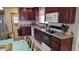 A functional kitchen featuring dark wood cabinetry and sleek, modern appliances at 3345 E University Dr # 47, Mesa, AZ 85213