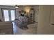 Living room boasts a comfortable recliner sofa, tiled floors, and natural light from the glass doors at 3345 E University Dr # 47, Mesa, AZ 85213
