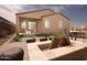 Inviting backyard featuring a cozy fire pit area, patio with outdoor seating, and well-maintained desert landscaping at 3610 E Peralta Canyon Ln, San Tan Valley, AZ 85140