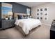 This bedroom features neutral carpet, a blue accent wall, and natural light at 3610 E Peralta Canyon Ln, San Tan Valley, AZ 85140