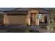 Charming single-story home with a desert landscape, brick driveway, and covered front porch, perfect for relaxing outdoors at 3610 E Peralta Canyon Ln, San Tan Valley, AZ 85140