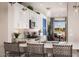 Bright kitchen with white cabinetry, granite countertops, and a stylish island with seating, ideal for casual dining at 3610 E Peralta Canyon Ln, San Tan Valley, AZ 85140