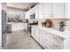 Modern kitchen featuring stainless steel appliances, white cabinetry, and ample counter space, perfect for cooking and entertaining at 3610 E Peralta Canyon Ln, San Tan Valley, AZ 85140