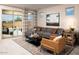 Beautifully decorated living room with a comfortable sofa, stylish rug, and plenty of natural light from sliding doors at 3610 E Peralta Canyon Ln, San Tan Valley, AZ 85140