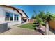 Backyard with a patio, an air conditioner, artificial grass and rock landscaping at 3877 E Oxford Ln, Gilbert, AZ 85295
