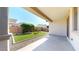 Backyard offers covered patio, easy-care artificial grass, and mature landscaping for outdoor enjoyment at 3877 E Oxford Ln, Gilbert, AZ 85295