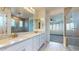 Bright bathroom featuring double vanity, granite counters, and a large glass-enclosed shower at 3877 E Oxford Ln, Gilbert, AZ 85295