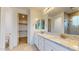 Elegant bathroom features a double vanity, walk in closet and large walk-in shower at 3877 E Oxford Ln, Gilbert, AZ 85295