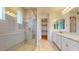 Bathroom boasts a glass-enclosed shower, double vanity, and modern fixtures at 3877 E Oxford Ln, Gilbert, AZ 85295